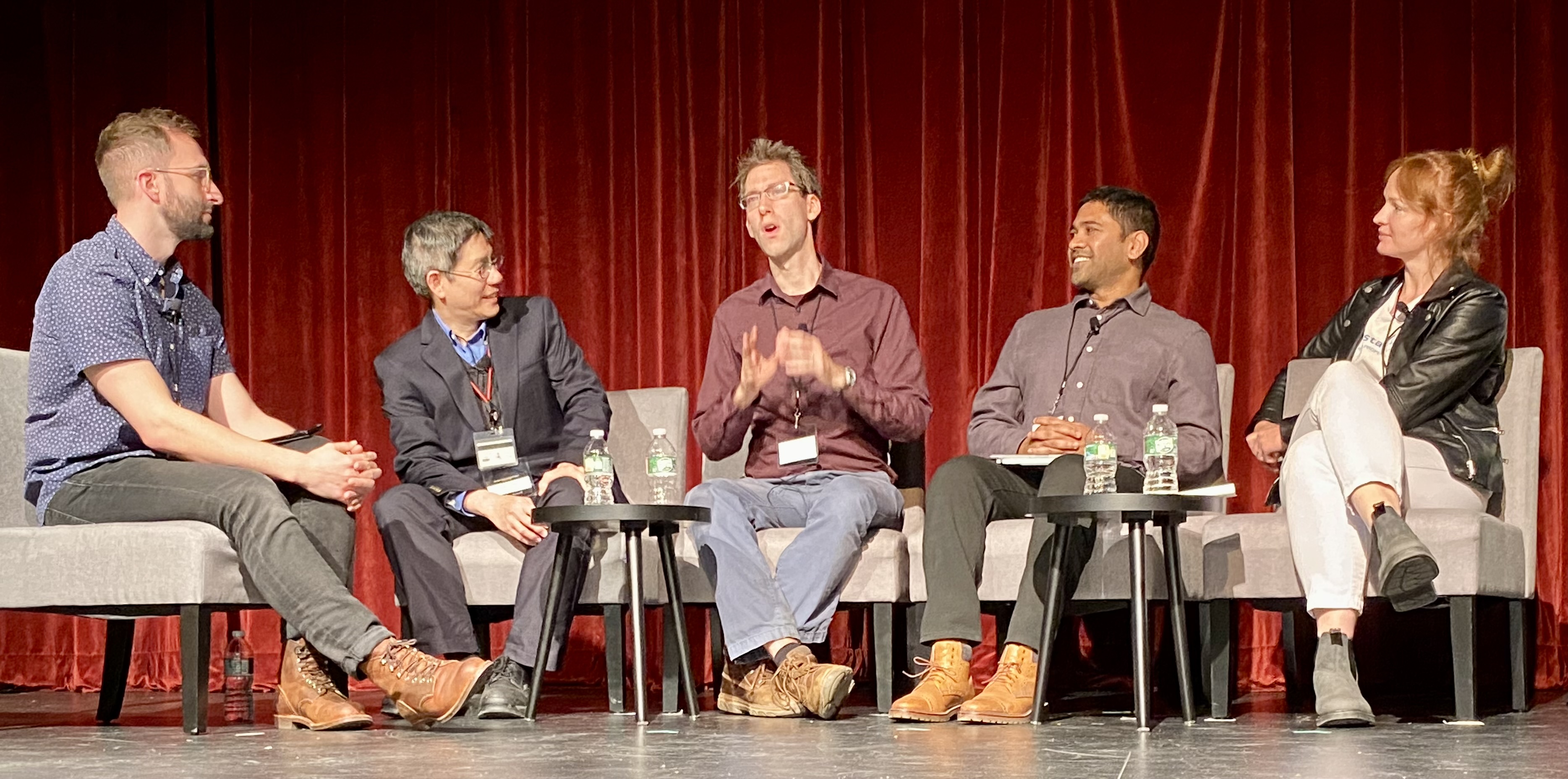 Panelists at "Convergence: The Promise and Reality of AI & Quantum" conference onstage